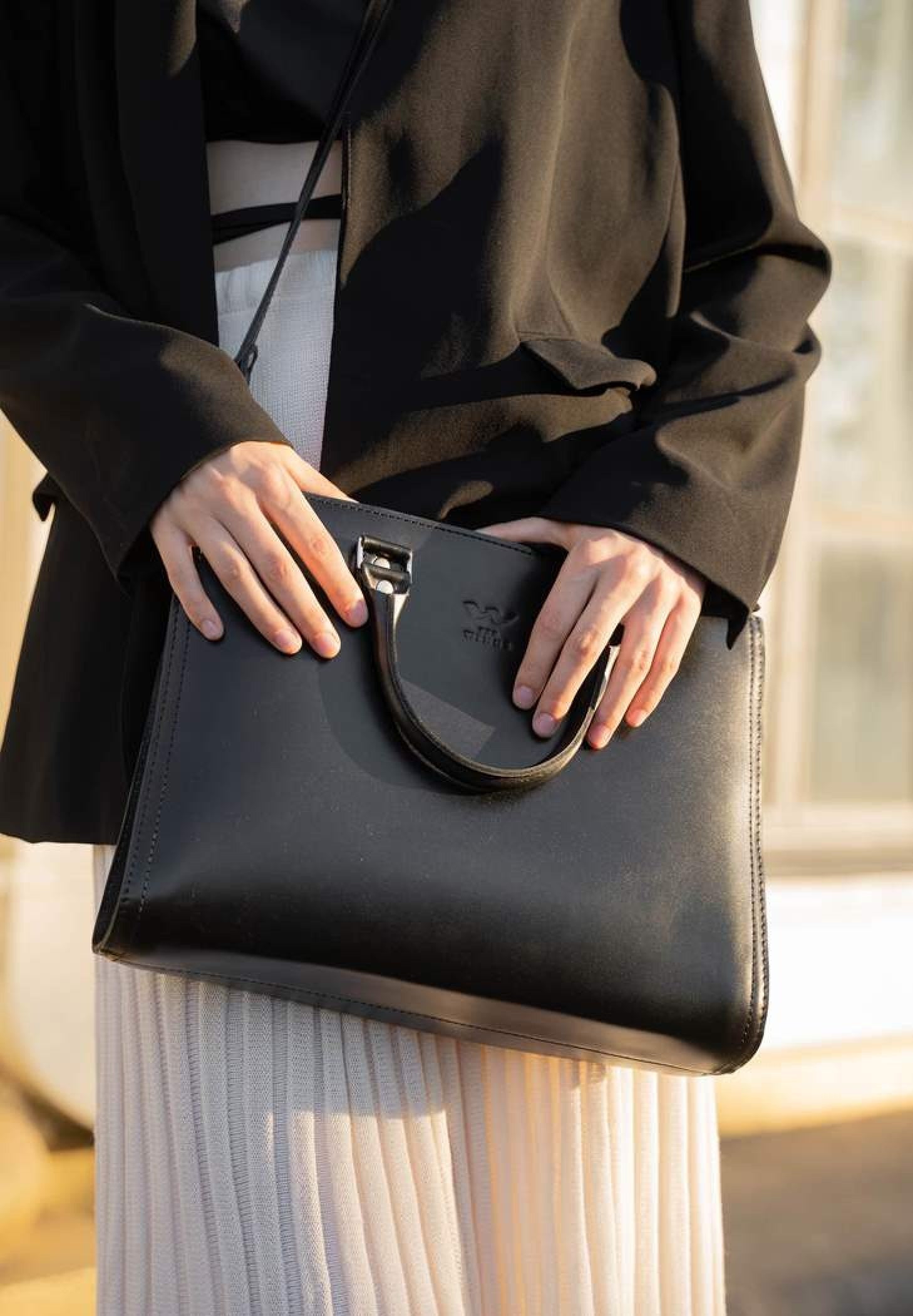a woman with a black leather bag