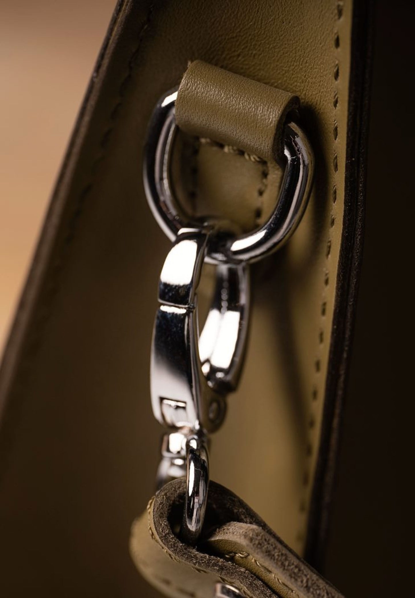 green olive leather bag with a silver detail