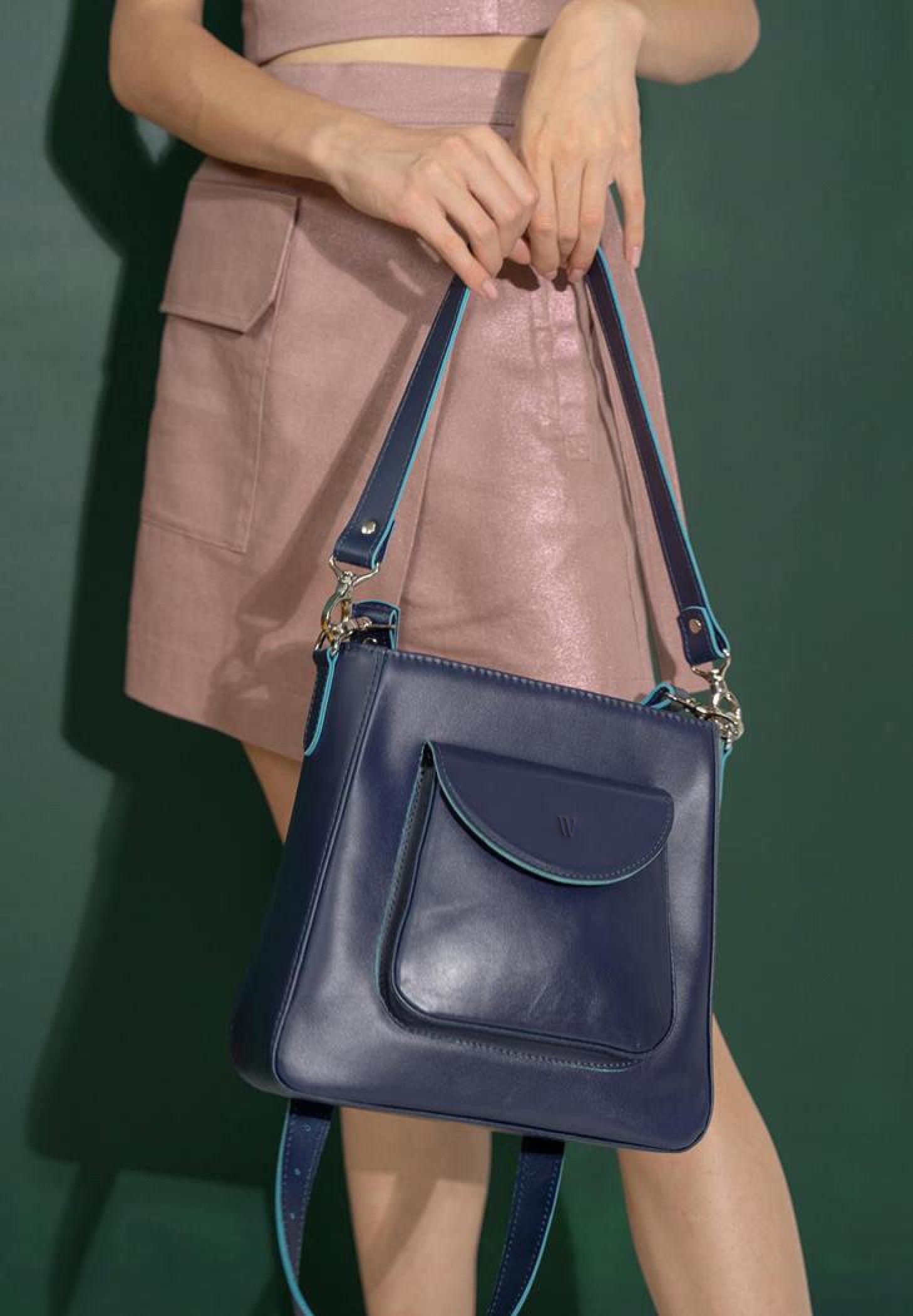 model is wearing a high quality leather bag for women in navy blue color