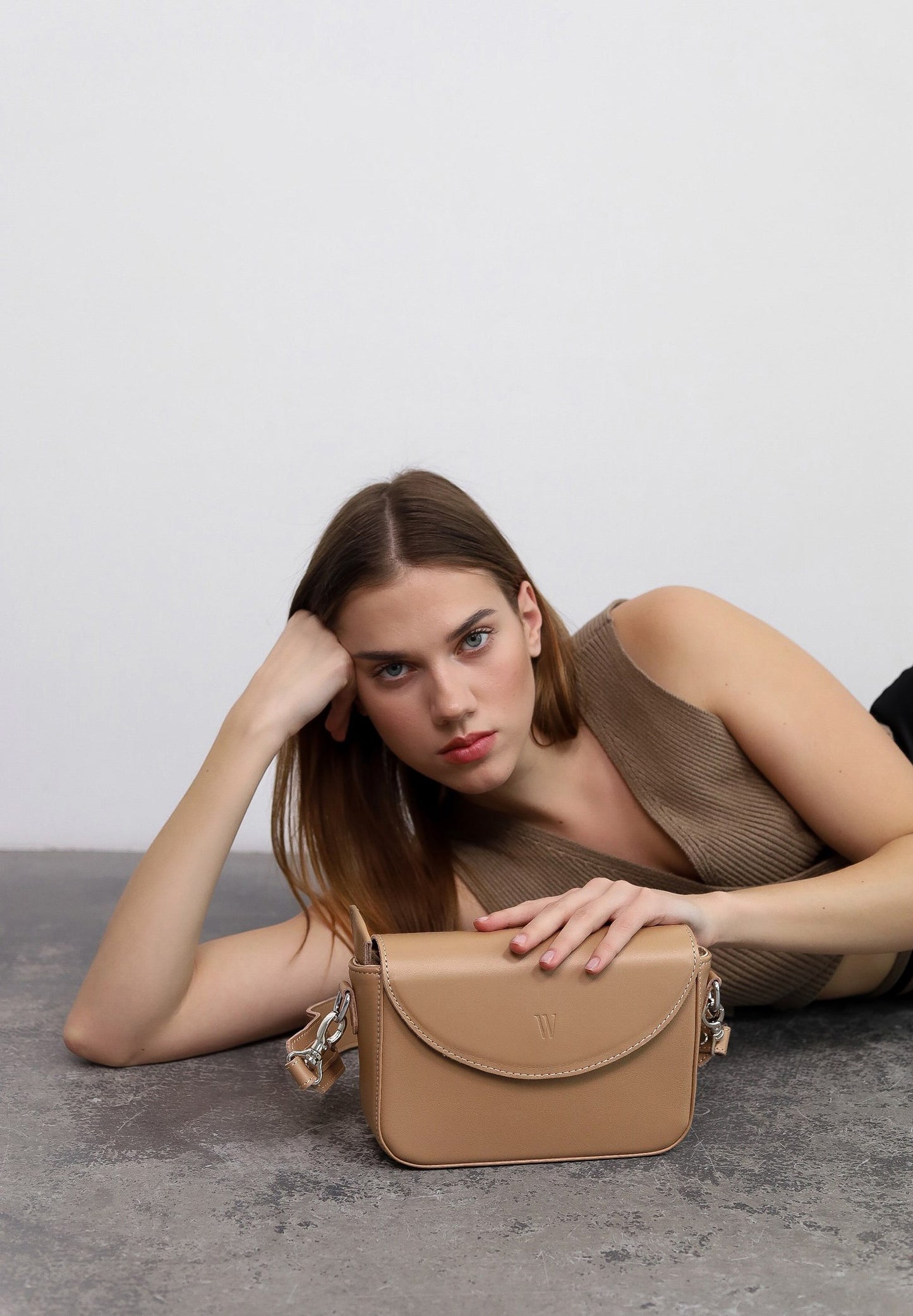beautiful woman holding a nude Molly leather bag for women