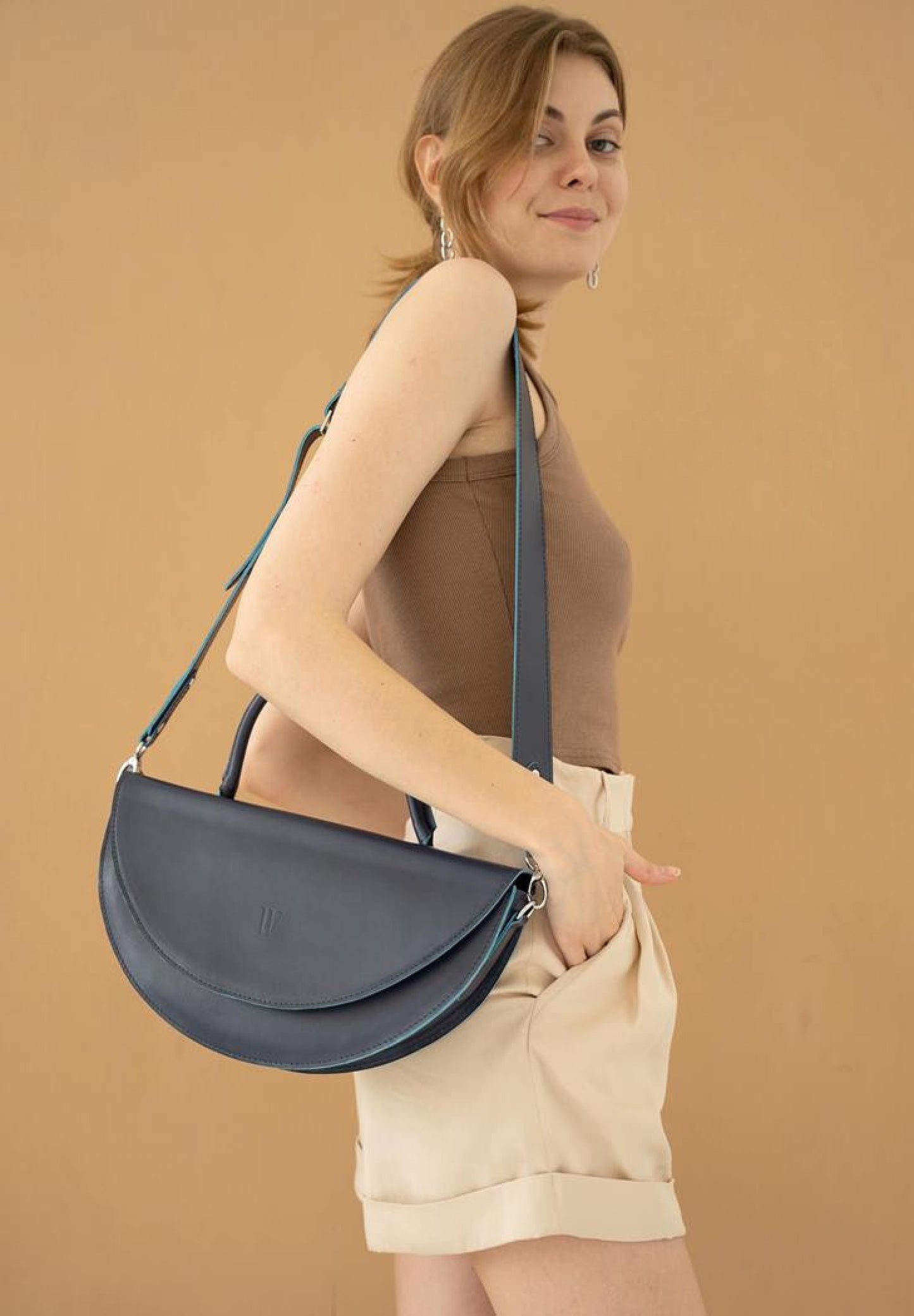 women wears a blue leather bag for women