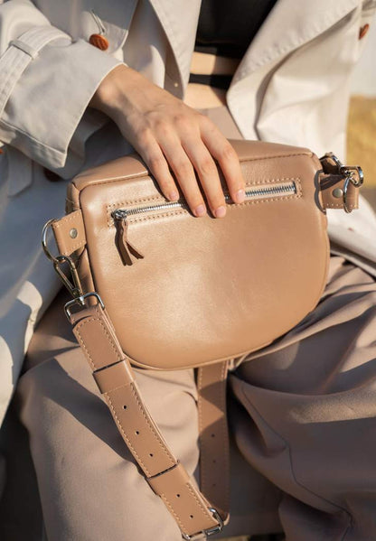 A woman is wearing caramel, nude leather crossbody bag, leather shoulder bag for women, leather shoulder bag for work, Single strap shoulder bag, Leather satchel bag, Minimalist leather shoulder bag, Genuine leather shoulder bag