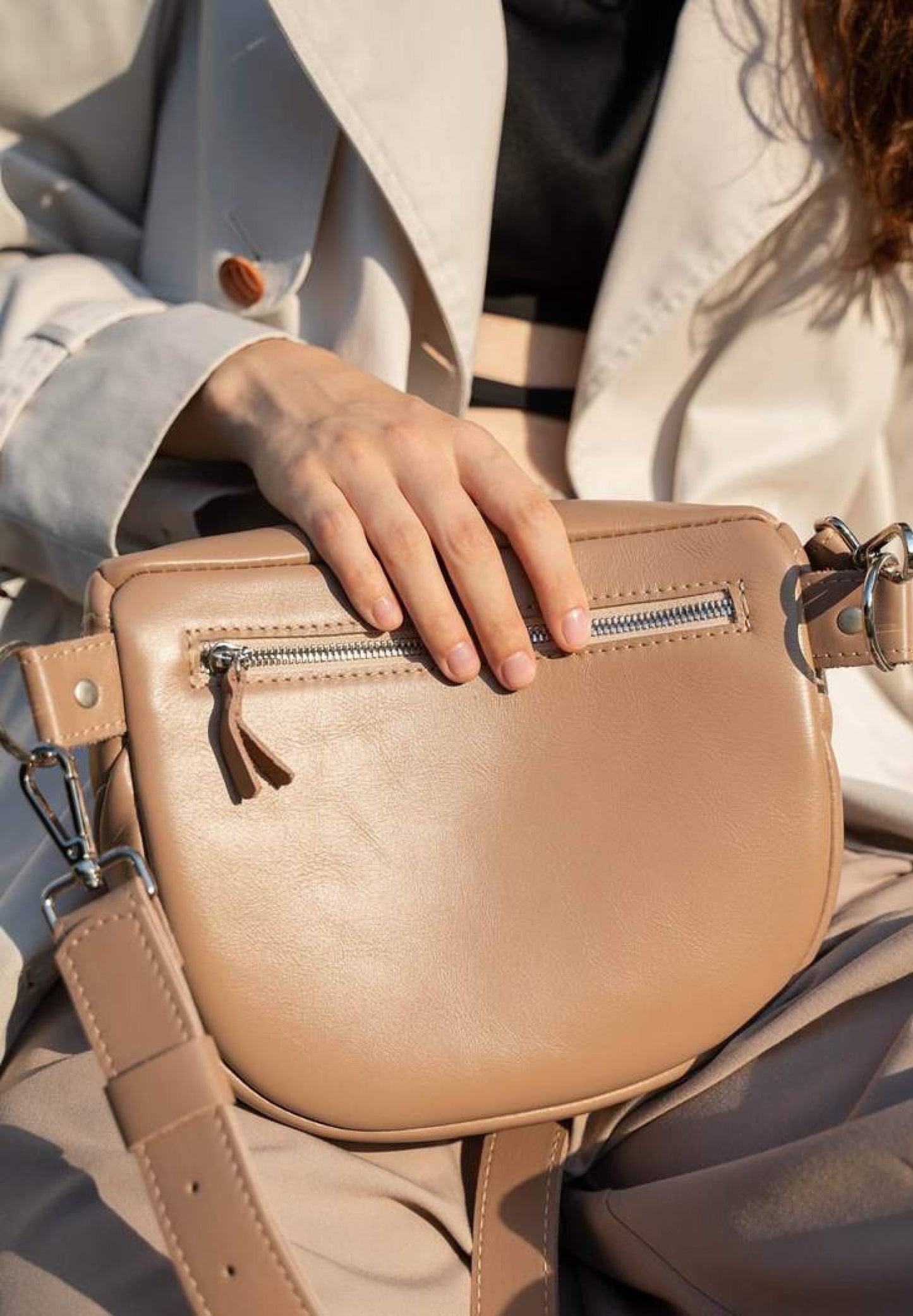 A woman is wearing caramel, nude leather crossbody bag, leather shoulder bag for women, leather shoulder bag for work, Single strap shoulder bag, Leather satchel bag, Minimalist leather shoulder bag, Genuine leather shoulder bag