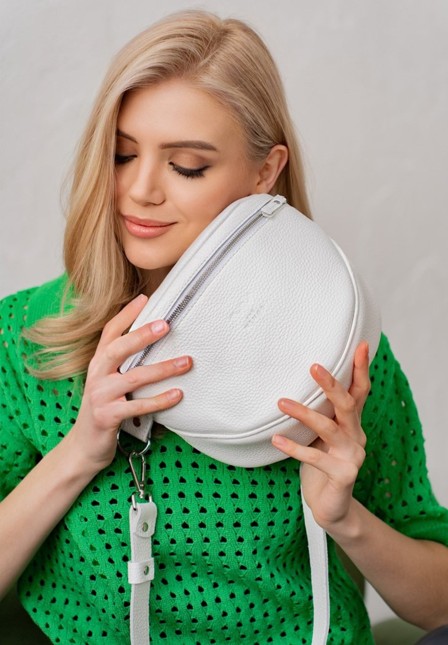 Blond woman is wearing a white leather crossbody bag for women, Premium genuine leather, Comfortable crossbody design, Adjustable strap, Perfect for everyday adventures